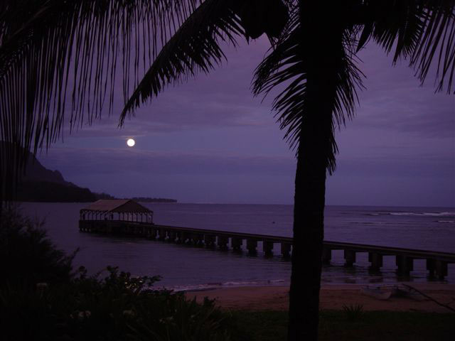Nearby historic Hanalei Pier with full moon setting, early morning